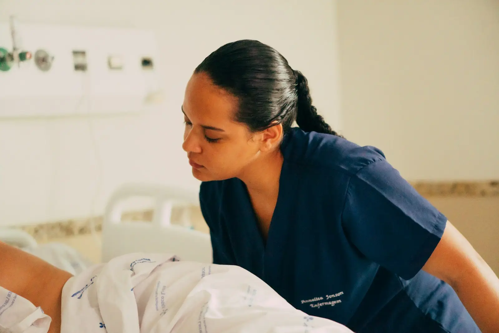 A nurse caring for a patient at a hospital bedside